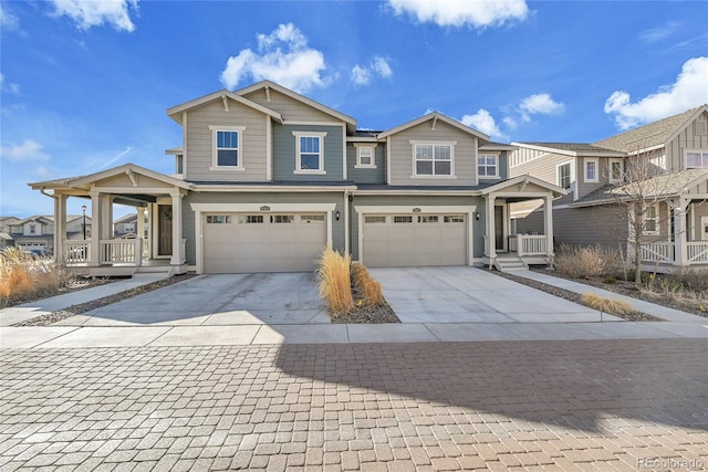 view of front of house with covered porch, driveway, and a garage