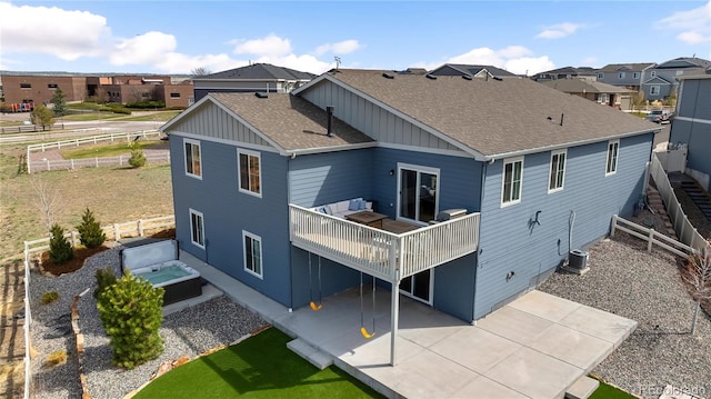 back of property with roof with shingles, a residential view, central AC unit, a fenced backyard, and a patio
