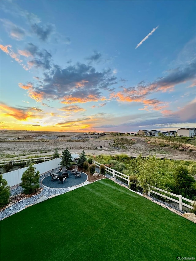 view of yard with a fenced backyard, a patio area, and an outdoor fire pit