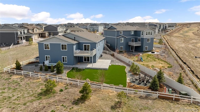 rear view of house featuring a patio, a residential view, and a fenced backyard