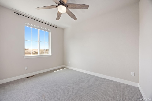 spare room featuring baseboards, ceiling fan, carpet flooring, and visible vents