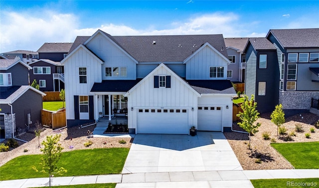 modern farmhouse with board and batten siding, fence, a garage, a residential view, and driveway