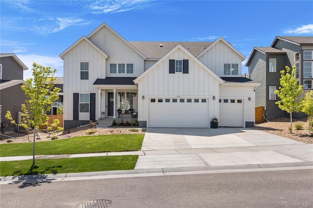 modern farmhouse style home with concrete driveway, roof with shingles, an attached garage, a front lawn, and board and batten siding