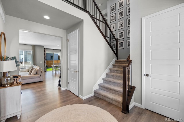 stairs featuring recessed lighting, baseboards, and wood finished floors