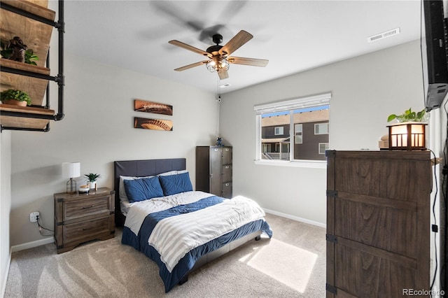 bedroom with light carpet, baseboards, visible vents, and ceiling fan