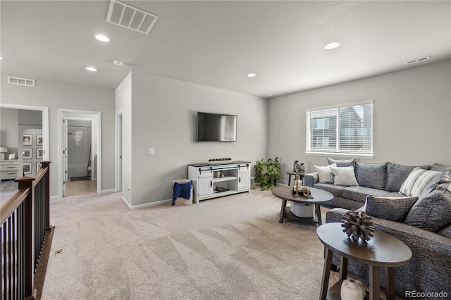 living room featuring light carpet, visible vents, and recessed lighting