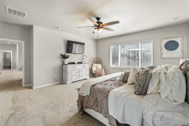 bedroom with baseboards, visible vents, ceiling fan, and light colored carpet