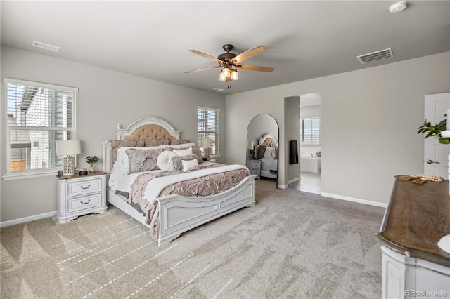 bedroom featuring multiple windows, visible vents, and light colored carpet