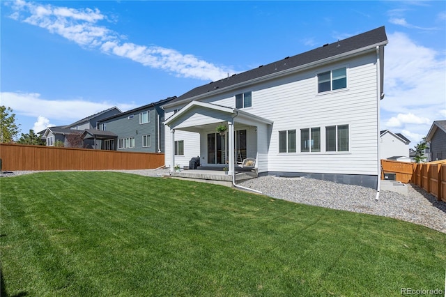 back of house featuring a fenced backyard, a lawn, and a patio