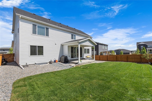 back of house with a yard, a patio area, and a fenced backyard