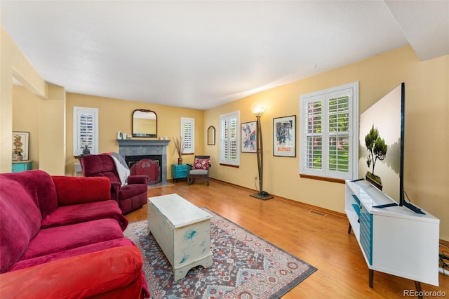 4390 S Sheridan Blvd, Littleton, CO 80123 - living area featuring a tile fireplace and wood finished floors