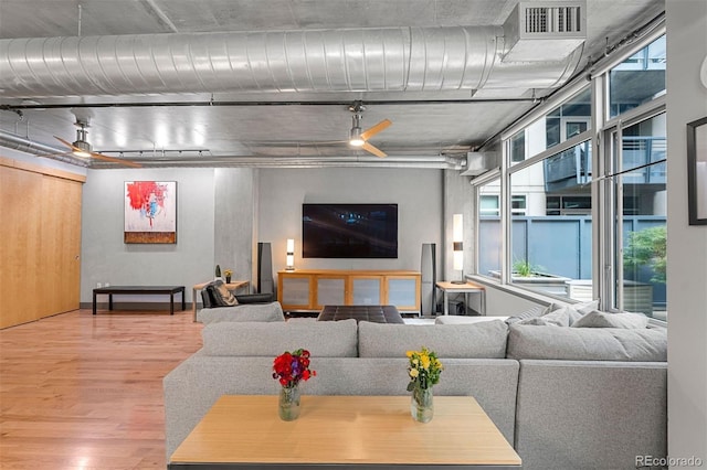 living room featuring ceiling fan and hardwood / wood-style floors