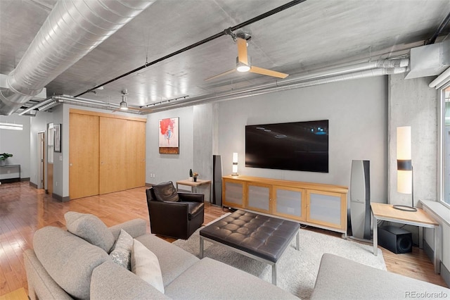 living room featuring ceiling fan and hardwood / wood-style floors