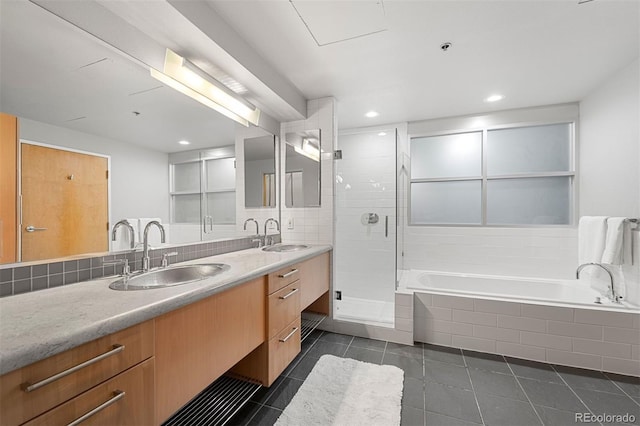 bathroom featuring tile patterned flooring, shower with separate bathtub, and vanity