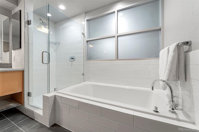 bathroom with independent shower and bath, tile patterned flooring, and vanity