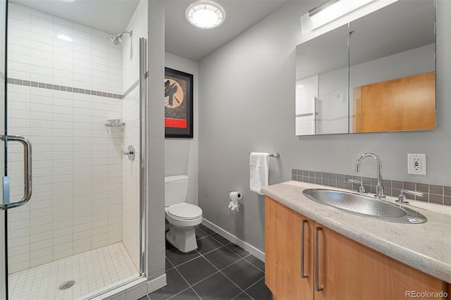 bathroom featuring toilet, an enclosed shower, vanity, and tile patterned floors