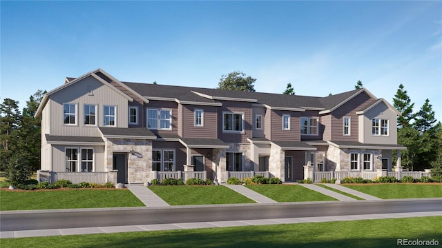 multi unit property with stone siding, a front lawn, and board and batten siding