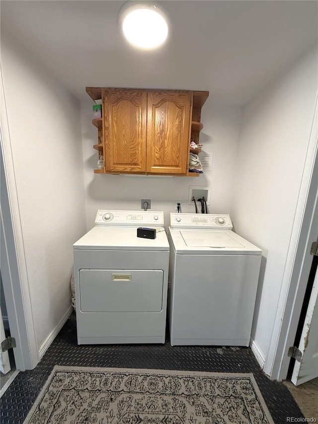183 E Ave, Limon, CO 80828 - laundry area featuring cabinet space, washing machine and clothes dryer, and baseboards