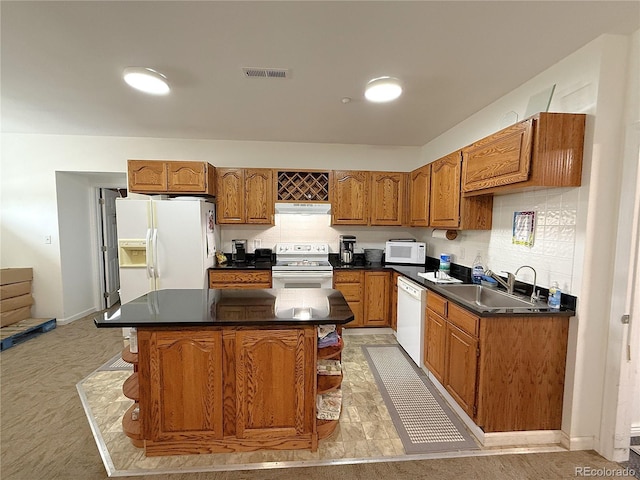 183 E Ave, Limon, CO 80828 - kitchen featuring white appliances, a sink, brown cabinetry, and under cabinet range hood
