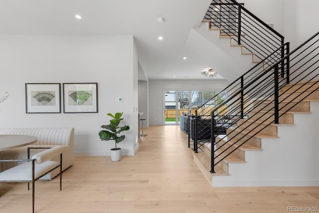 entrance foyer with stairs, wood finished floors, baseboards, and recessed lighting