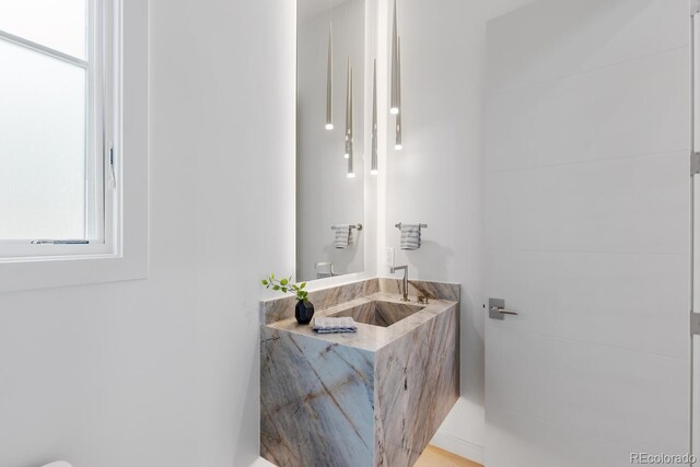 half bathroom with healthy amount of natural light and vanity