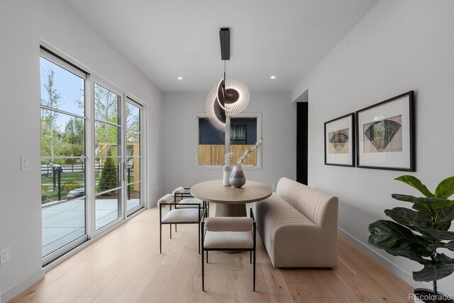 dining space featuring light wood-type flooring, recessed lighting, and baseboards