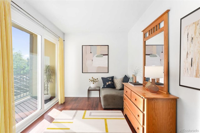 sitting room with dark wood-type flooring