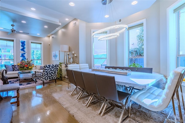dining area with recessed lighting, ceiling fan with notable chandelier, visible vents, and wood finished floors