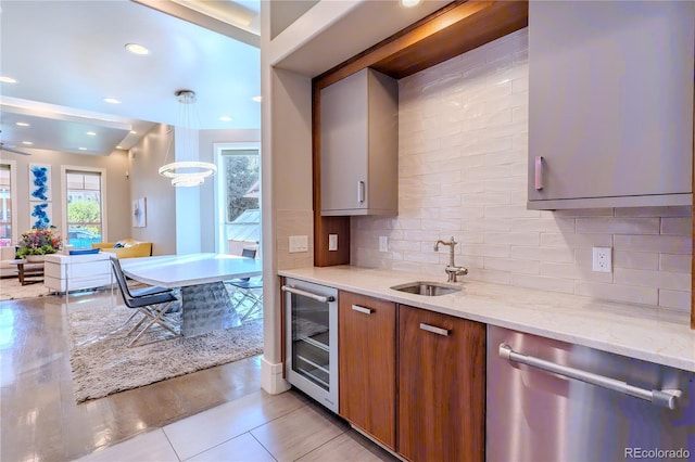 kitchen with beverage cooler, dishwasher, light stone counters, a sink, and brown cabinets