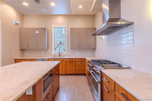 kitchen with backsplash, appliances with stainless steel finishes, light stone countertops, and wall chimney exhaust hood
