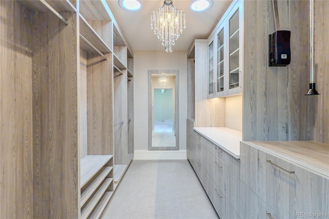 spacious closet with a notable chandelier