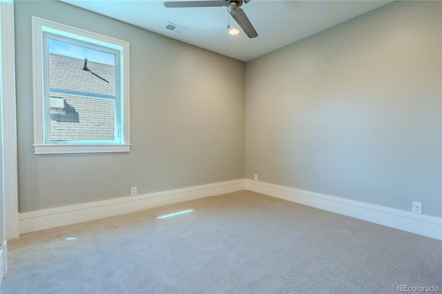 spare room with visible vents, baseboards, a ceiling fan, and carpet floors