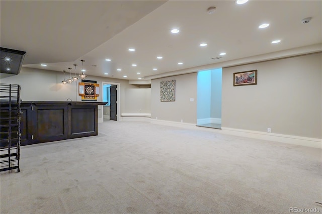 finished below grade area with bar, light carpet, baseboards, and recessed lighting