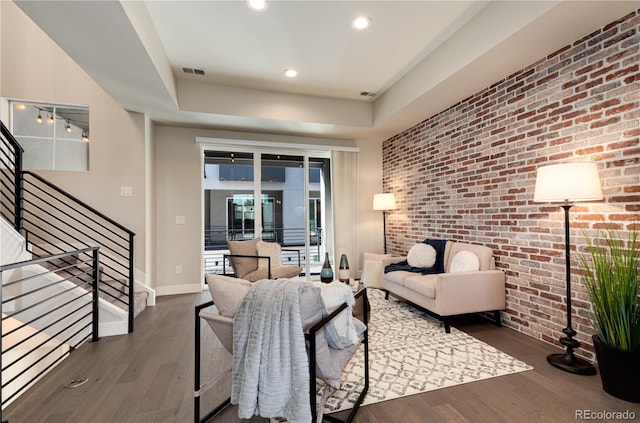 7861 W 51st Ave Unit B, Arvada, CO 80002 - living room with wood finished floors, brick wall, recessed lighting, stairs, and a raised ceiling