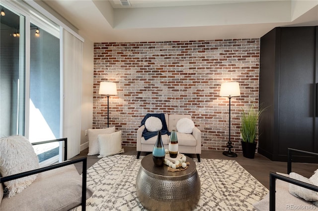 7861 W 51st Ave Unit B, Arvada, CO 80002 - sitting room with brick wall and wood finished floors