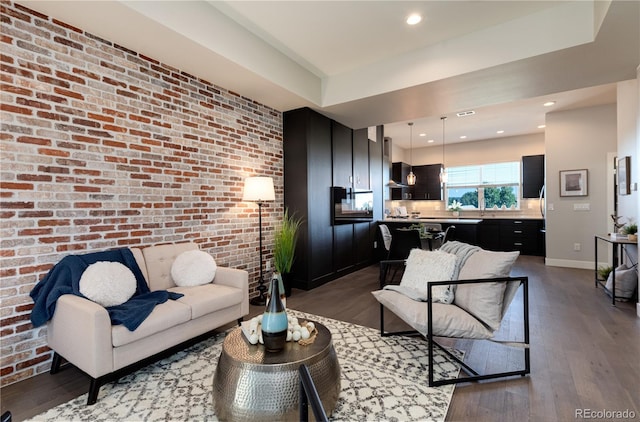 7861 W 51st Ave Unit B, Arvada, CO 80002 - living area featuring wood finished floors, brick wall, and recessed lighting