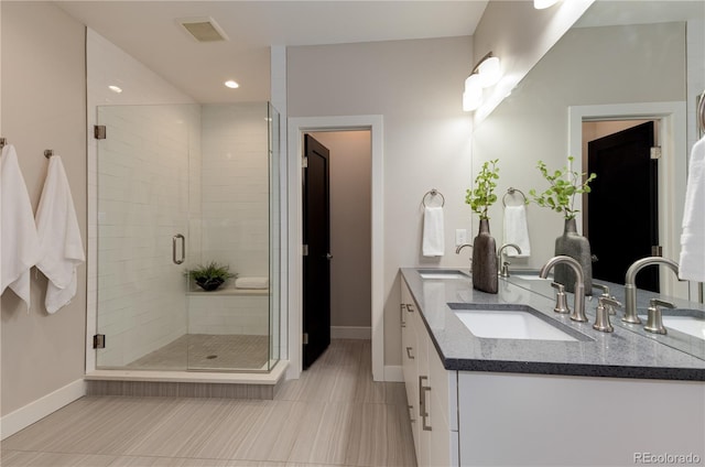 7861 W 51st Ave Unit B, Arvada, CO 80002 - bathroom with double vanity, a shower stall, recessed lighting, and tile patterned flooring
