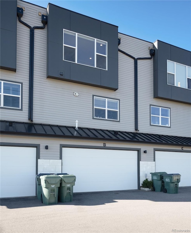 7861 W 51st Ave Unit B, Arvada, CO 80002 - view of front of home featuring a standing seam roof, a garage, and a metal roof