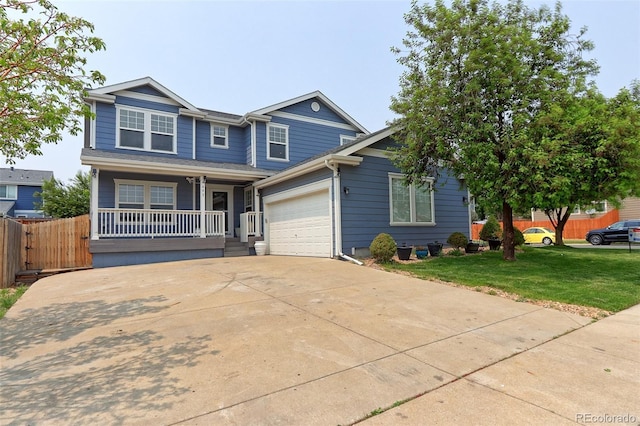 view of front of property with a front lawn, covered porch, and a garage