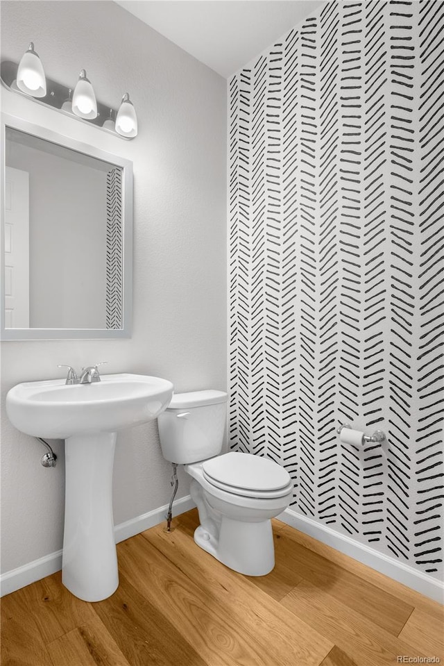 8028 Williams Fork Ave, Littleton, CO 80125 - half bathroom with wood finished floors and toilet
