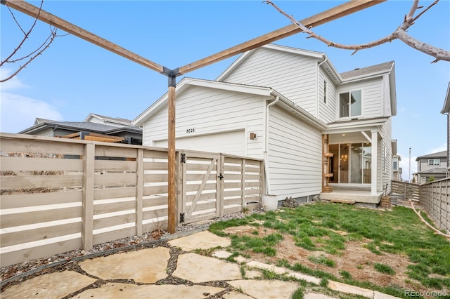 8028 Williams Fork Ave, Littleton, CO 80125 - back of house with a fenced backyard and a garage