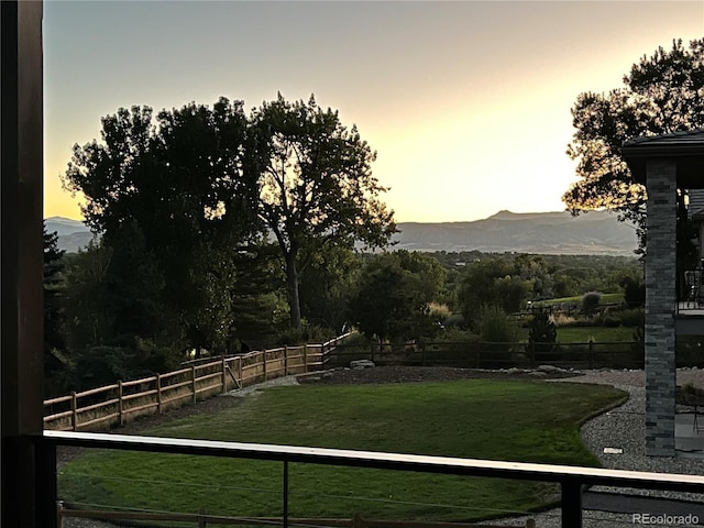 view of yard with a mountain view and fence