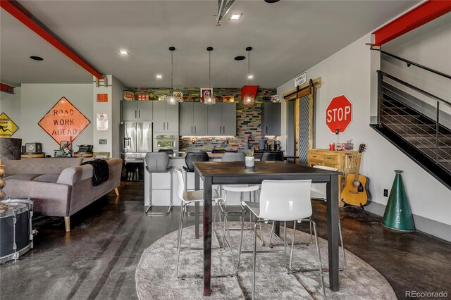 interior space with recessed lighting and a barn door