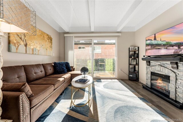1265 Race St Unit 203, Denver, CO 80206 - living area featuring wood finished floors, a fireplace, baseboards, and beamed ceiling