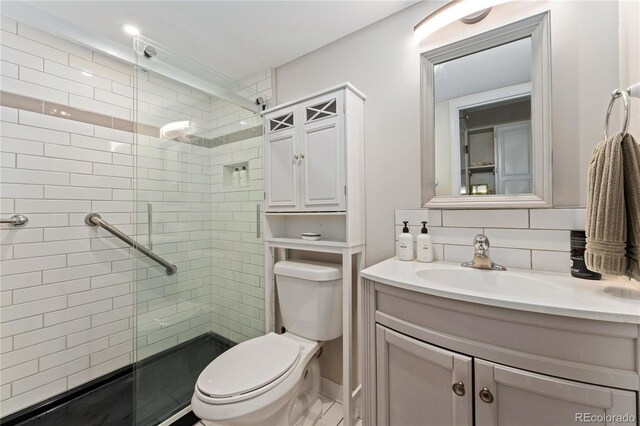 1265 Race St Unit 203, Denver, CO 80206 - bathroom with toilet, a shower stall, vanity, and tasteful backsplash