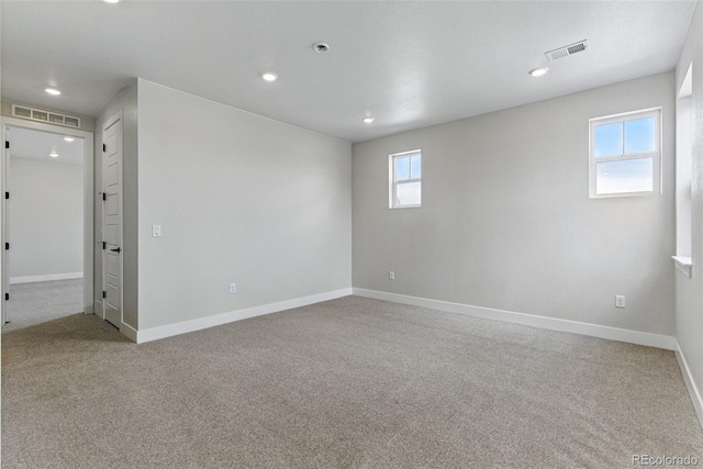 carpeted spare room with baseboards, recessed lighting, and visible vents