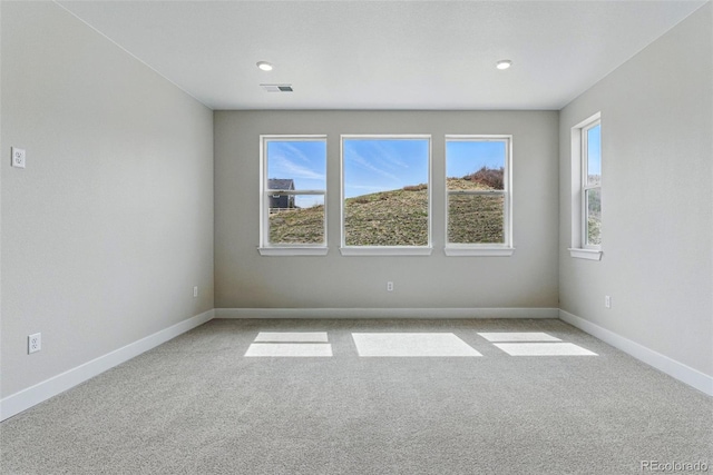 empty room with recessed lighting, visible vents, baseboards, and carpet floors