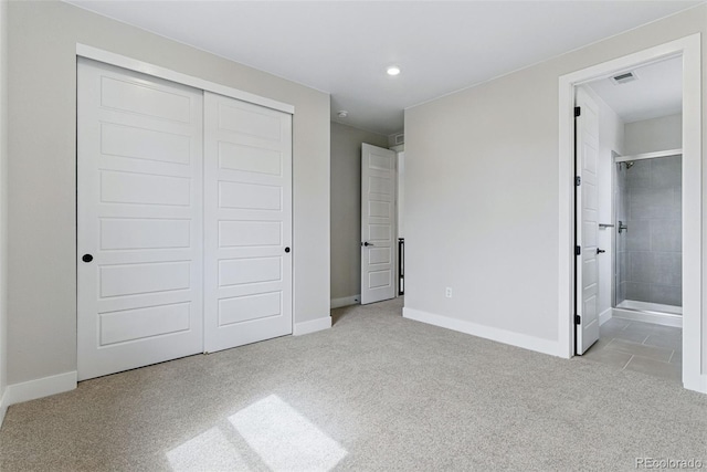 unfurnished bedroom featuring connected bathroom, a closet, carpet floors, visible vents, and baseboards