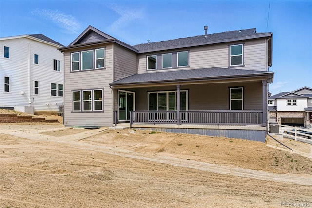 back of property with a porch