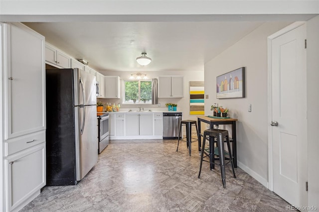 5645 W 5th Ave Unit 5645 & 5655, Lakewood, CO 80226 - kitchen featuring appliances with stainless steel finishes, white cabinets, and light countertops
